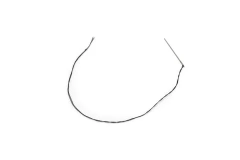 Black thread in a needle on a white background 스톡 사진