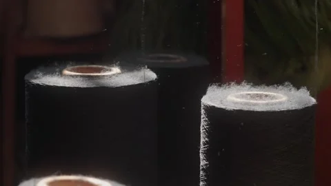 Black Thread Spools with Fibers Rising in Slow Motion Stock Footage 327508201