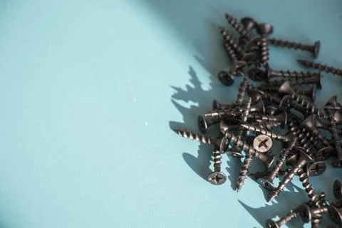 Black threaded screw on the green background Stock Photos