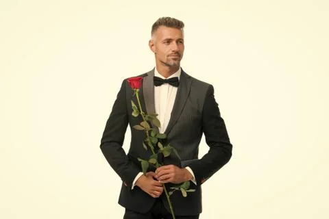Black tie dress code for evening events. tuxedo man with rose flower. happy Stockfoto's