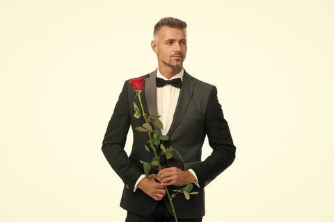 Black tie dress code for evening events. tuxedo man with rose flower. happy Stock Photos