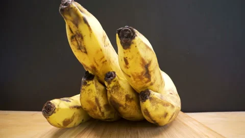 The black tip of the ripe banana fruit on the table Stock Footage 135704565