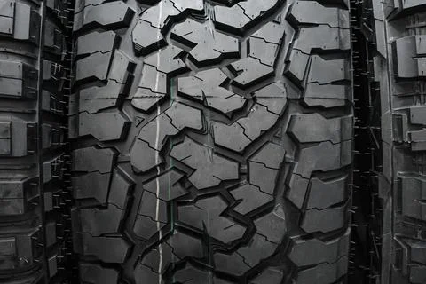 Black tire tread texture background with detailed rubber pattern. Stock Photos