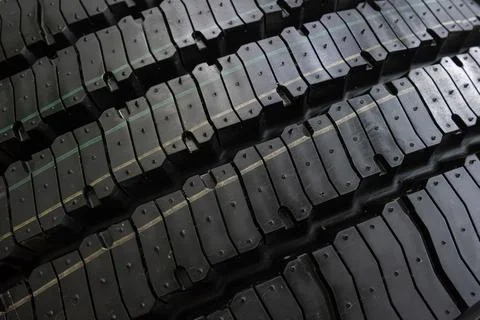 Black tire tread texture background with detailed rubber pattern. Stock Photos