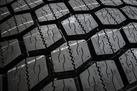 Black tire tread texture background with detailed rubber pattern. Stock Photos
