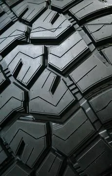 Black tire tread texture background with detailed rubber pattern. Stock Photos