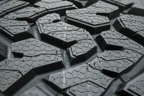 Black tire tread texture background with detailed rubber pattern. Stock Photos