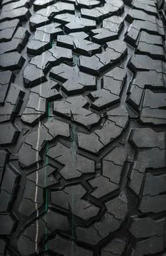 Black tire tread texture background with detailed rubber pattern. Stock Photos