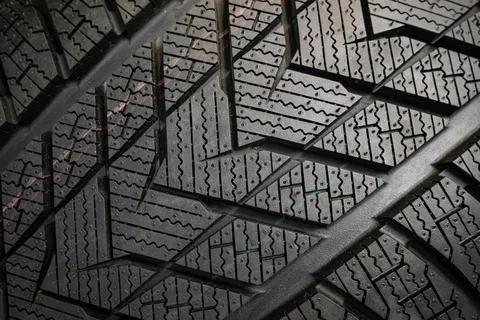 Black tire tread texture background with detailed rubber pattern. Stock Photos