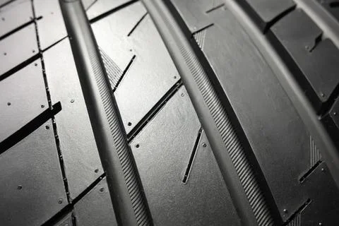Black tire tread texture background with detailed rubber pattern. Stock Photos