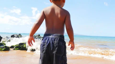 Black toddler playing in the ocean Stock Footage 52916976