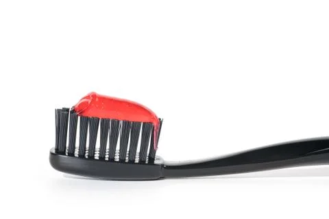 Black toothbrush with red toothpaste isolated on white Stock-Fotos