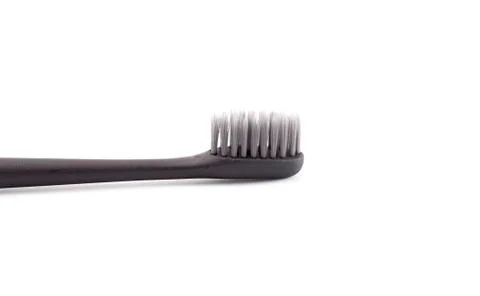 A Black Toothbrush without Toothpaste on a White Background Stock Photos