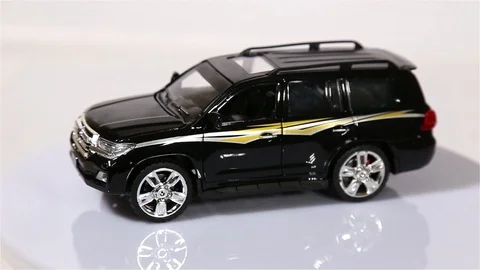 Black Toyota VX-R scale model SUV car is rotating isolated on white background. Stock Footage 101688271