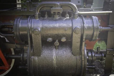 A black train engine with a black and red handle Photos