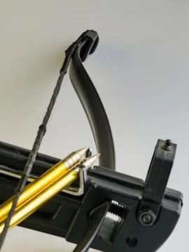 Black training crossbow with black string and arrows on a white background... Stock Photos
