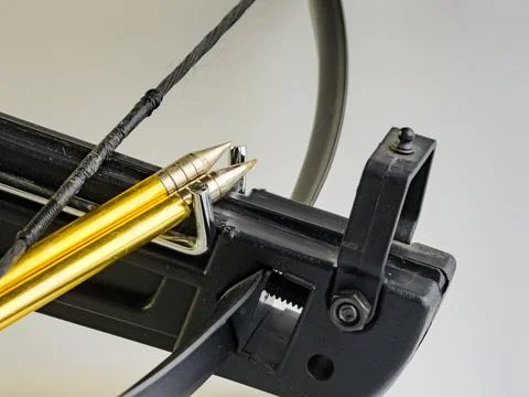 Black training crossbow with black string and arrows on a white background... Stock Photos