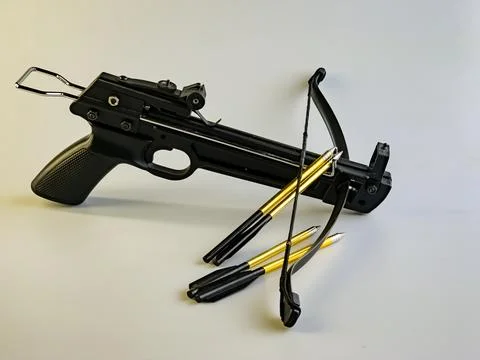 Black training crossbow with black string and arrows on a white background. Stock Photos