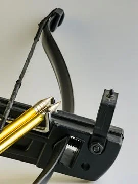 Black training crossbow with black string and arrows on a white background... Stock Photos