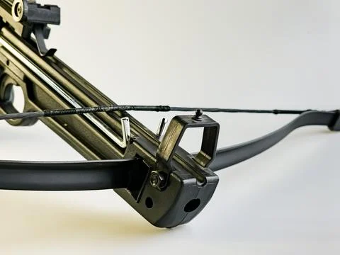 A black training crossbow with a sleek design and a black string on a white.. Stock Photos