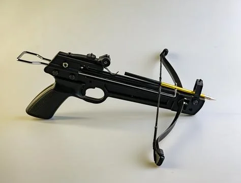 A black training crossbow with a sleek design and a black string on a white b Stock Photos