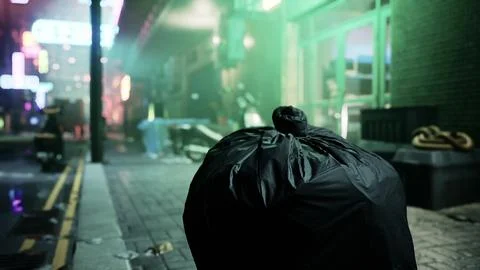 A black trash bag sitting on the side of a road Illustrazione stock