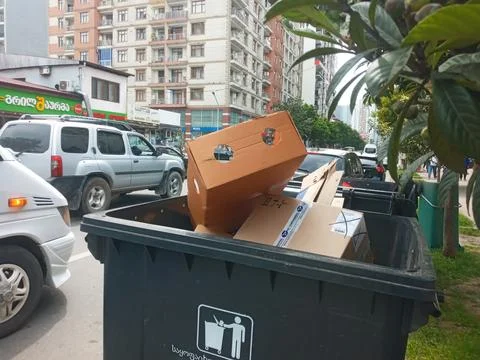 Black trash container with garbage Stock Photos