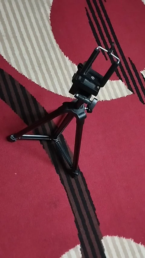 A black tripod is very useful for creating YouTube content Stock Footage 224798409