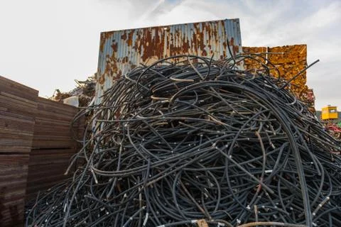 Black tube stack filled with wire rope in a junkyard Stock Photos