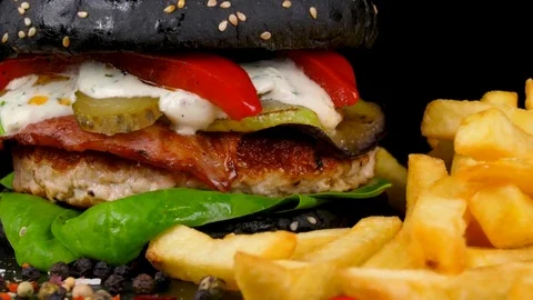 Black Turkey Burger with bacon and grilled vegetables, served with Fried Potato Stock Footage 84652226