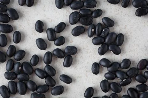 Black turtle beans on bright surface top view Stock Photos