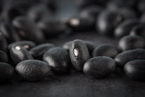 Black turtle beans on dark surface extreme closeup Stock Photos