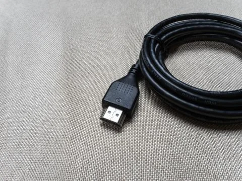 Black twisted hdmi cable for Sony PlayStation console on the table 07 04 2019 Stock Photos
