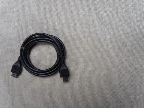 Black twisted hdmi cable for Sony PlayStation console on the table 07 04 2019 Stock Photos