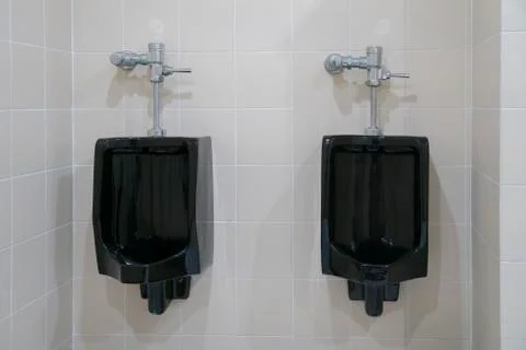 Black urinal of men with tile wall Stock-Fotos