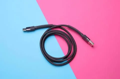 Black usb cable on blue and pink background Stock Photos