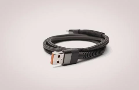 Black usb cable with orange connector on white background Stock Photos