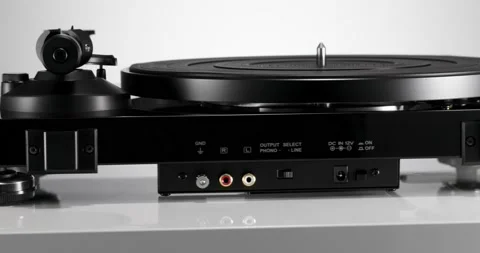 Black varnished record player spinning on white table Stock Footage 155860153
