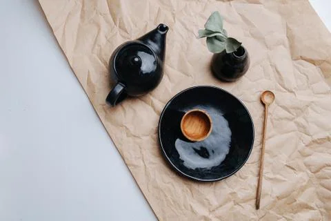 Black varnished tableware ceramic set. Fired, polished and dyed. Top view. Stock Photos