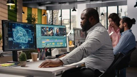 Black videographer refining footage with artificial intelligence tools Stock Photos