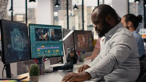 Black videographer refining footage with artificial intelligence tools Stock Photos