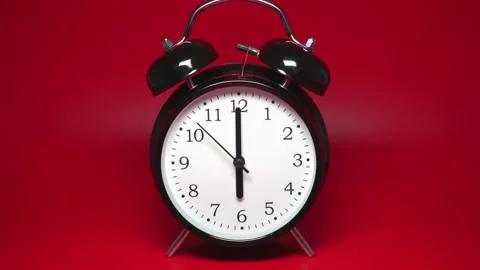 Black vintage alarm clock with two bells on red background Stock Footage 168470728