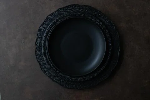 Black Vintage Ceramic Plate Stack on Dark Table Background Stock Photos
