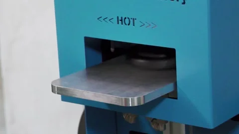 Black Vinyl Puck Emerging From Manufacturing Machine Stock Footage 343659972