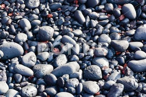 Black vulcanic stones on a black sand beach as a background, El Golfo, Lanzar Stock Photos