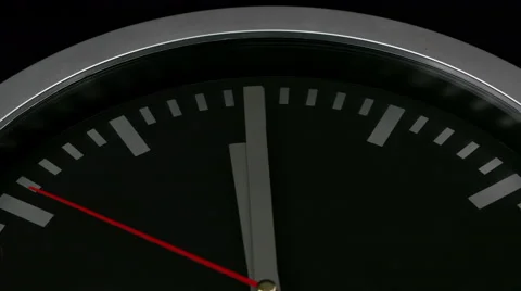 Black wall clock on black background, ticking the last seconds before twelve Video stock 46718560
