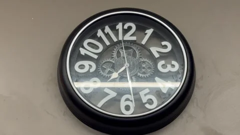 Black Wall Clock Ticking in Retro Diner Interior 動画素材 340998480