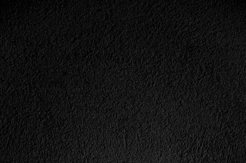 Black wall close up. Abstract background of painted black wall. Stock Photos