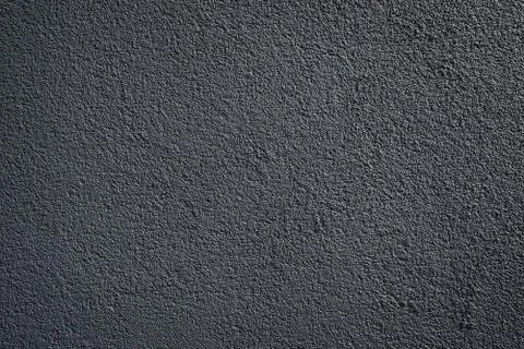 Black wall roughcast plaster background texture Stock Photos