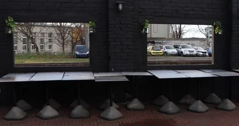 Black wall windows framing railway lot and parked cars Stock Footage 321048962